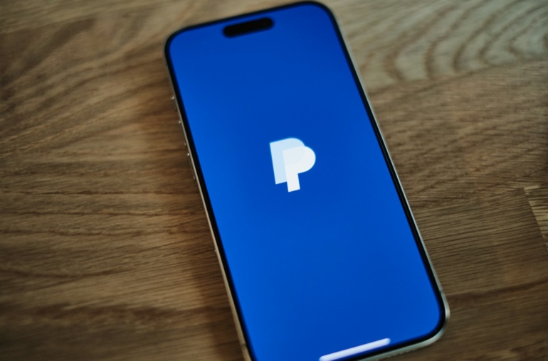 A blue iPhone sitting on top of a wooden table