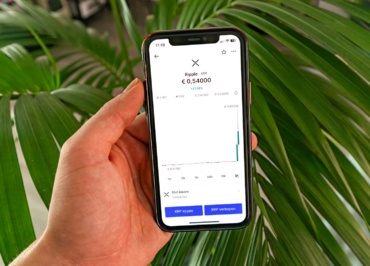 a person holding a cell phone in their hand