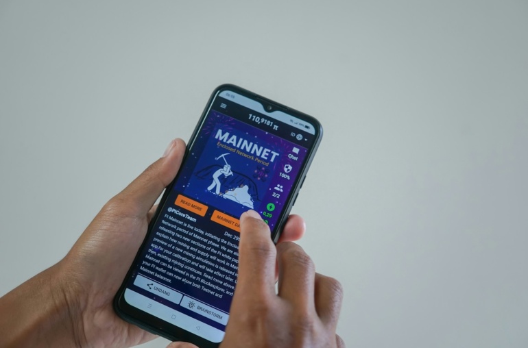 a person holding a cell phone with a website on the screen