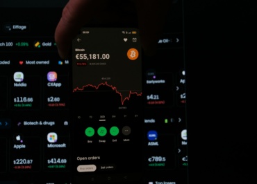 A person holding a cell phone in their hand