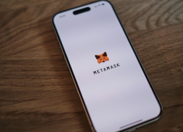 A cell phone sitting on top of a wooden table