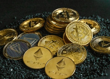 a pile of bitcoins sitting on top of a pile of gravel