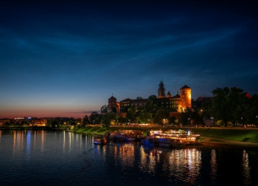 A lake with boats in it and a city in the background