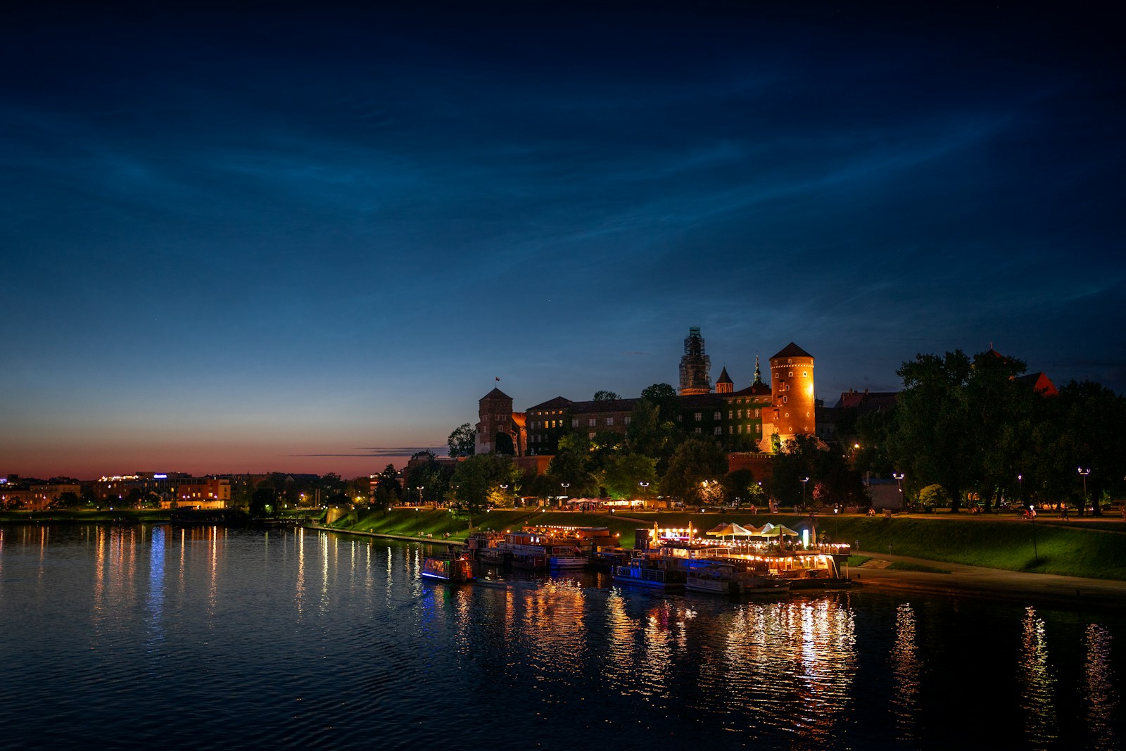 A lake with boats in it and a city in the background