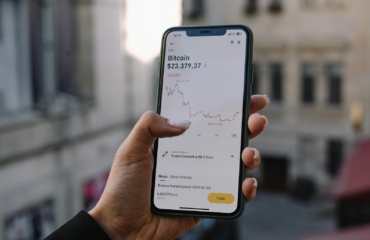 a person holding a cell phone in their hand