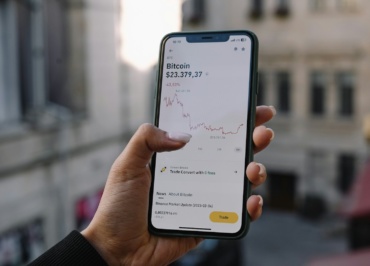 a person holding a cell phone in their hand