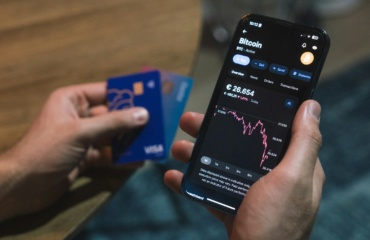 a person holding a cell phone in their hand