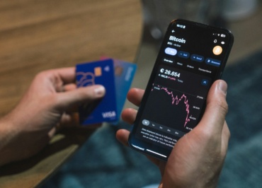 a person holding a cell phone in their hand