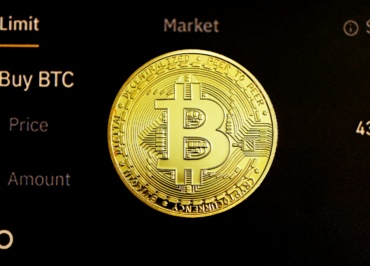 gold round coin on black surface