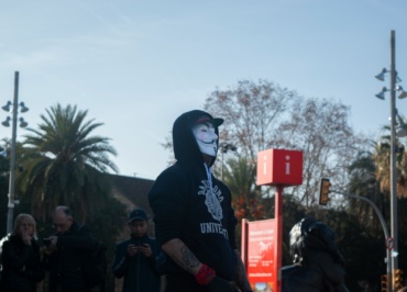 man in black hoodie standing near green palm tree during daytime