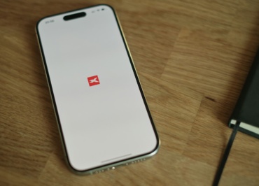 A cell phone sitting on top of a wooden table