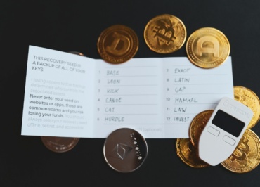 a cell phone sitting on top of a pile of coins